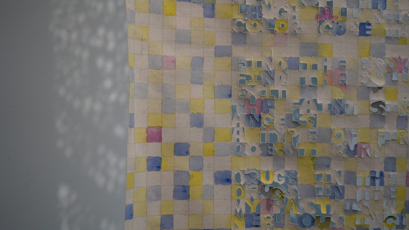 Textile detail: watercolour grid and cut letters