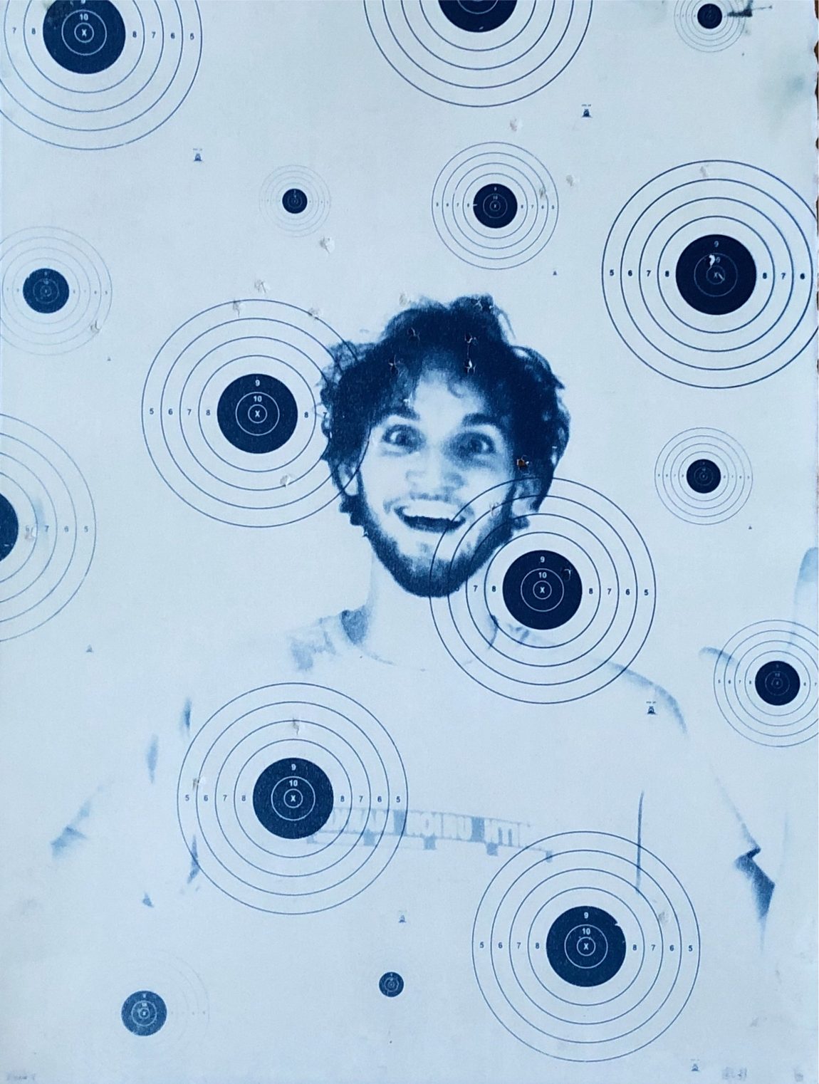 Cyanotype: figure with camera behind a bullseye