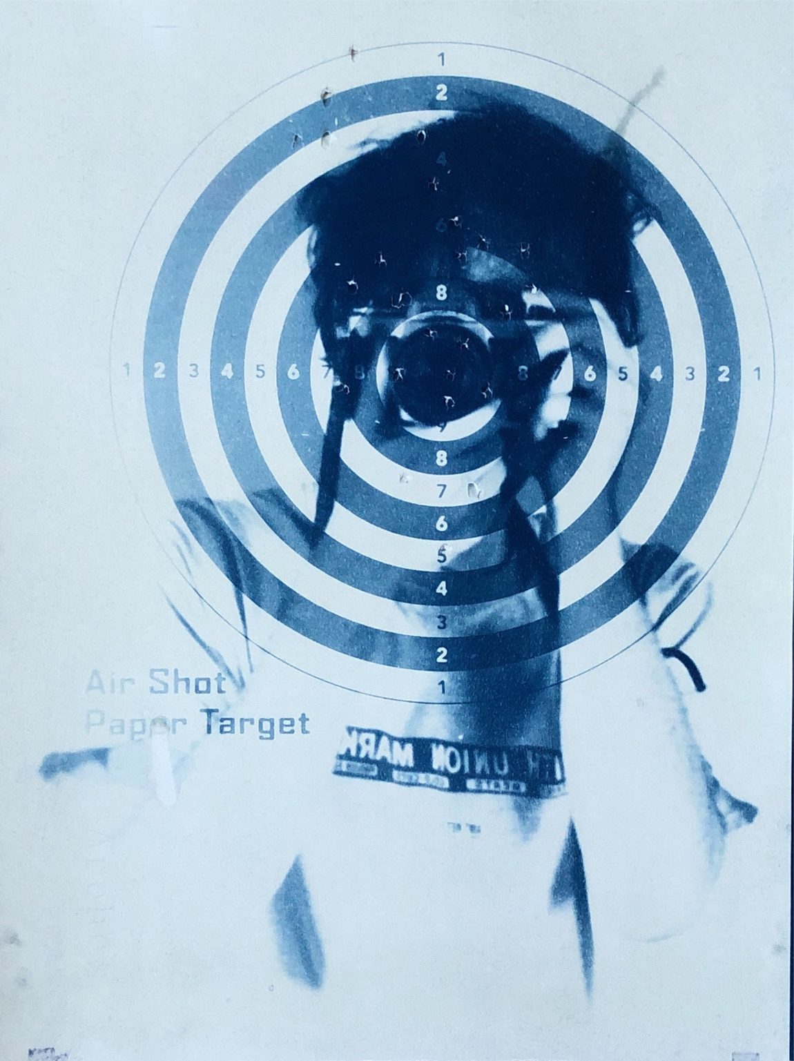 Cyanotype: smiling portrait scattered with bullseyes
