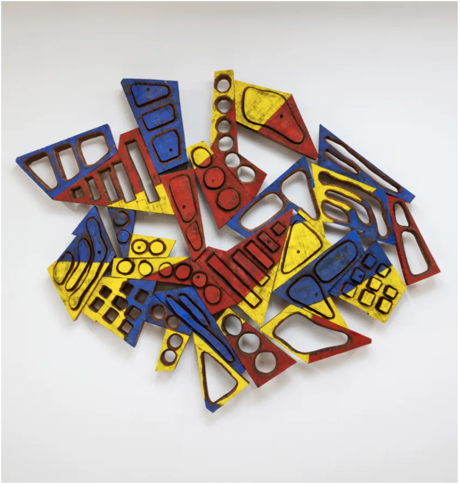 Wall-mounted relief in yellow, red and blue