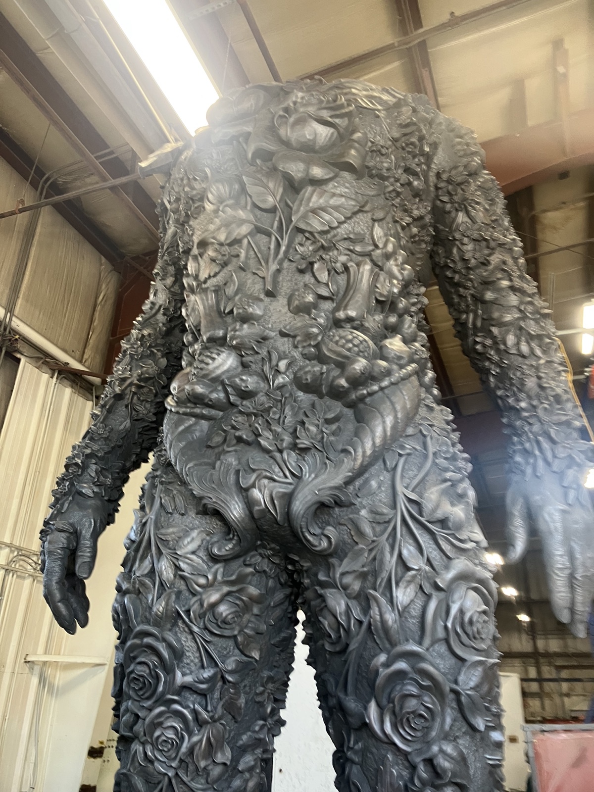 Cast metal figure of Amalgam standing in the shop
