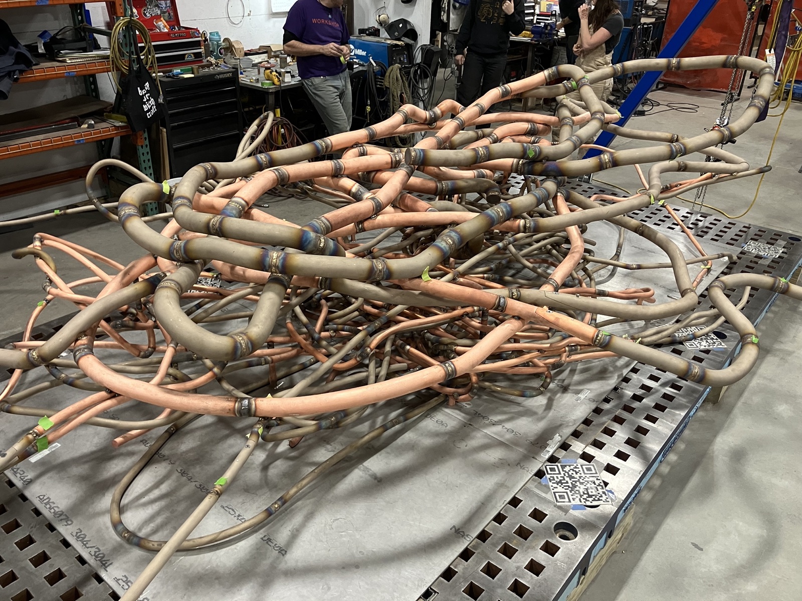 Tangled steel and copper tubing mid-assembly